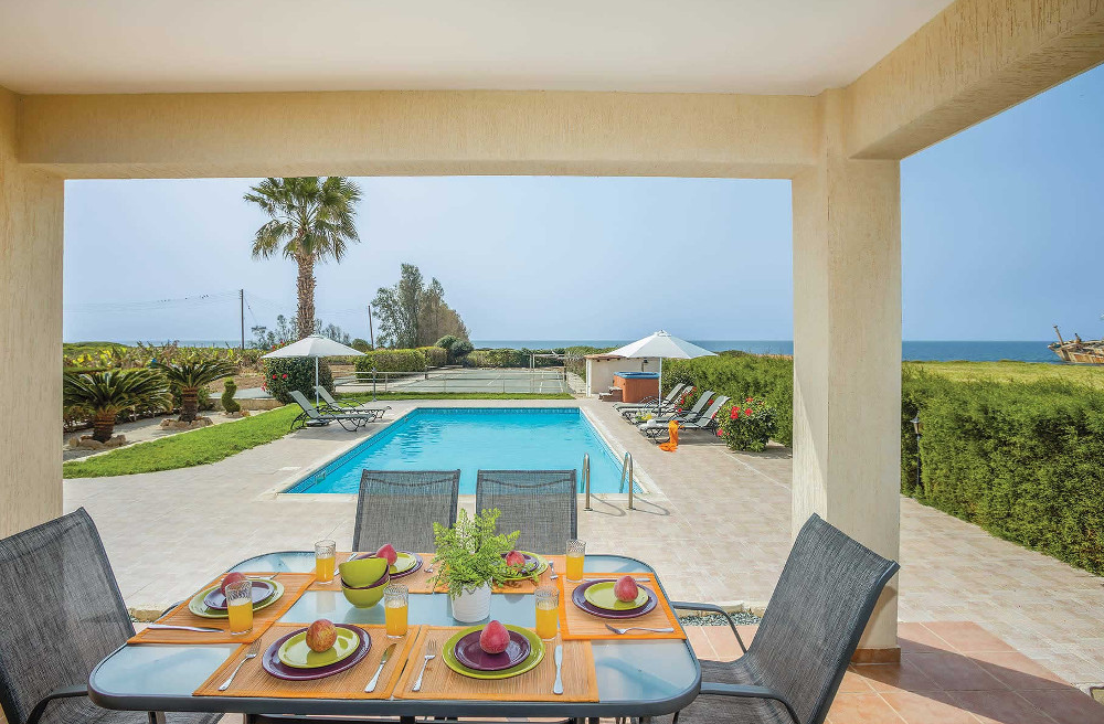 Villa Sweet Water has a shaded dining area, with views across the swimming pool to the sea