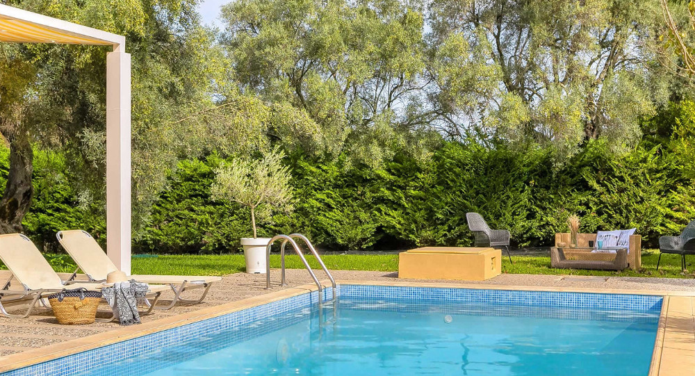 The pool and sun loungers at Villa Maria in Agios Ioannis, Lefkas