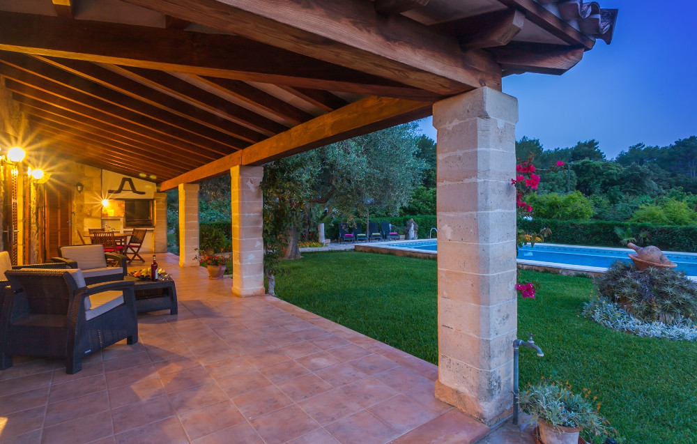 The shaded dining area and garden at La Taulera