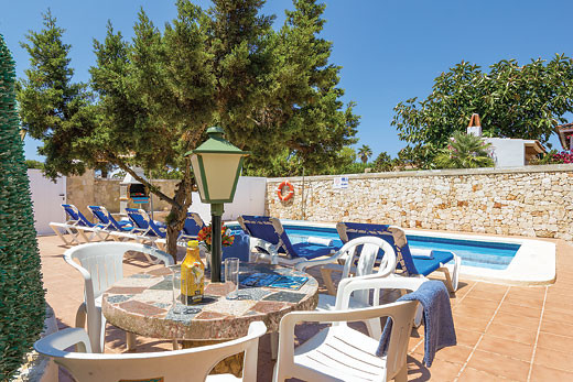 The pool and garden at Villa Casa Blanca in Cala Blanca